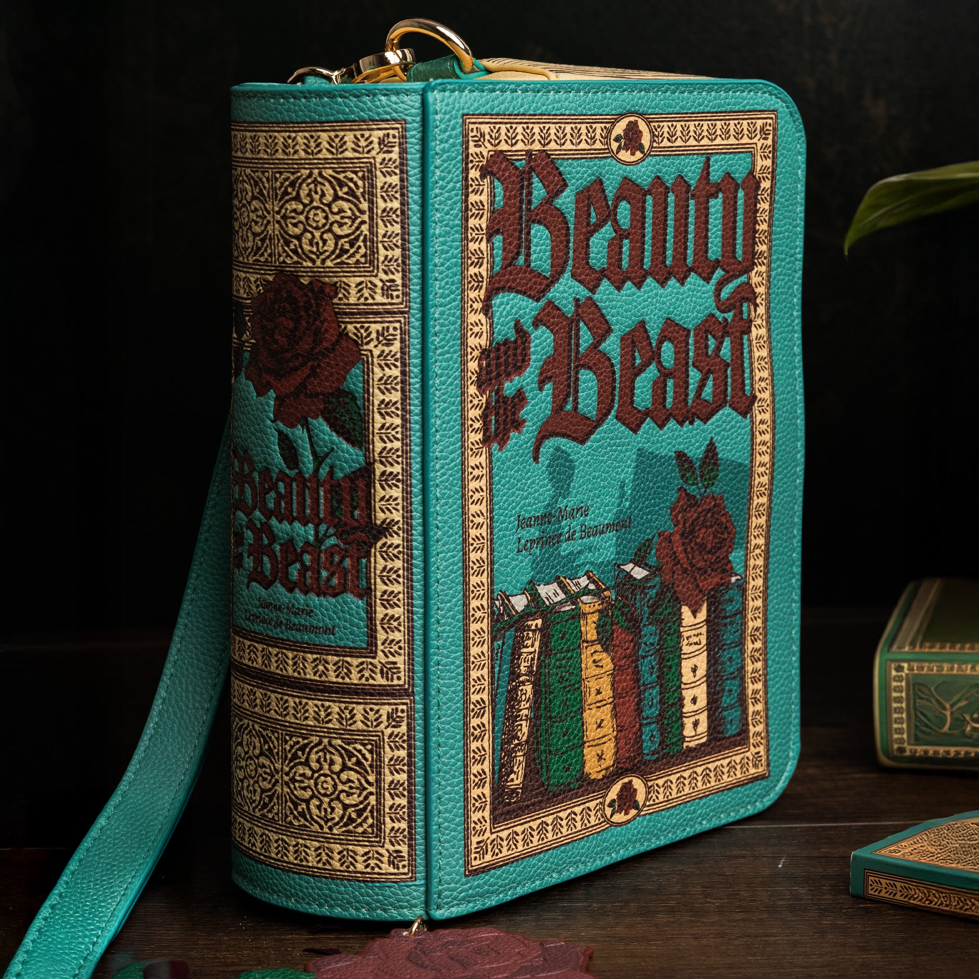 Book-shaped handbag with 'Beauty and the Beast' design on a dark background