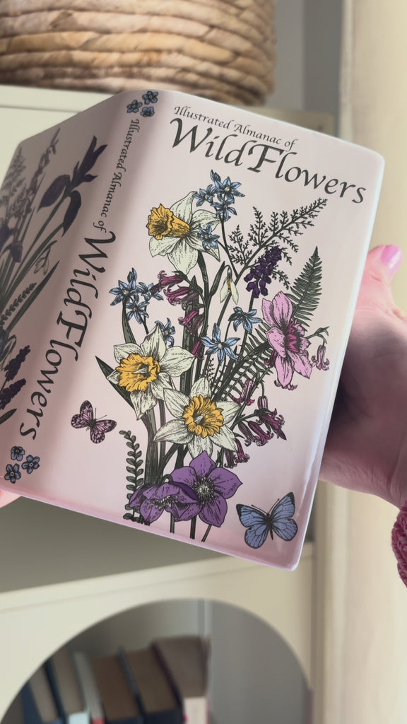 model showcasing wildflowers open 'book' vase